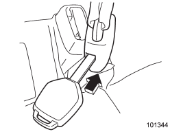 1. Insert a key or other hard pointed object into the slot in the connector (buckle)